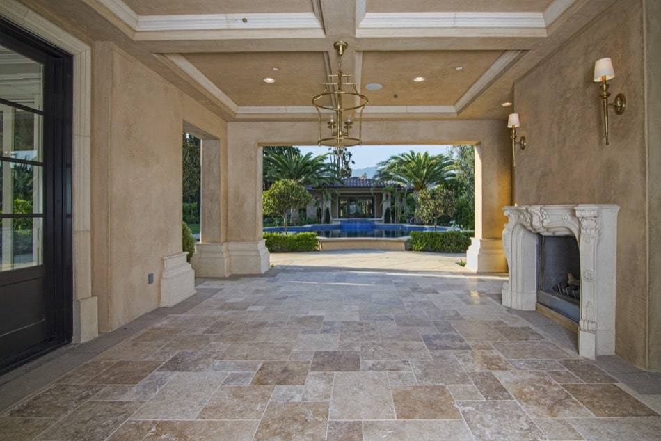 Outdoor Fireplace Lounge bordered by heavy columns as part of estate built by Richard Smith Custom Home Development